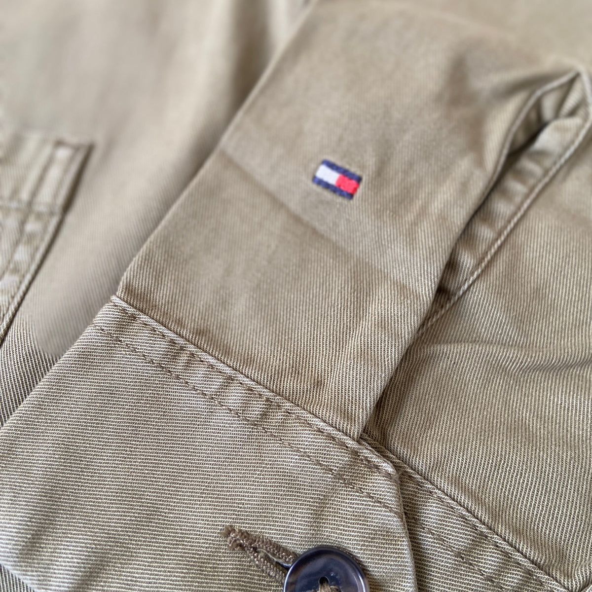 Tommy Hilfiger workwear chore jacket by BITAMBS, featuring durable fabric, classic design, and multiple front pockets.